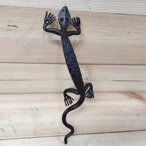 May include: Black metal lizard door handle with a textured finish. The lizard is in a standing position with its tail curled up.