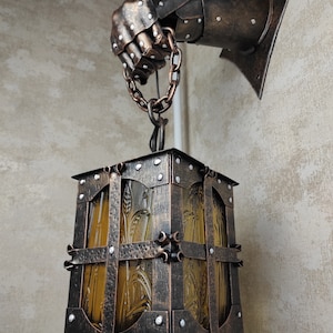 Wrought iron wall lamp on a metal knight&#39;s hand. Wall lantern, Ceiling lantern, Wrought iron sconces, lantern centerpiece, Medieval lantern
