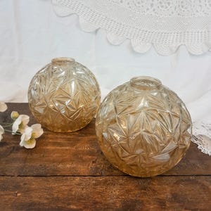 Pair of amber glass ball vases