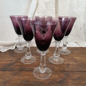 6 Purple colored blown glass stemmed glasses.