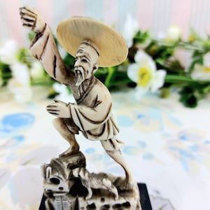 Chinese fisherman statuette with his dog