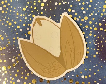 May include: A brown and white sticker with a stylized illustration of a pod or seed with a white interior and a brown exterior. The pod is surrounded by three brown leaves.