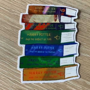 May include: A sticker of a stack of seven Harry Potter books. The books are stacked from smallest to largest, with the first book being "Harry Potter and the Philosopher's Stone" and the last book being "Harry Potter and the Deathly Hallows".