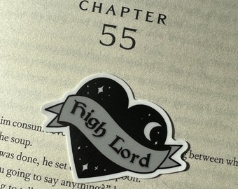 May include: A black and white sticker with a heart shape and the text "High Lord" inside. The heart has a crescent moon and stars on it.
