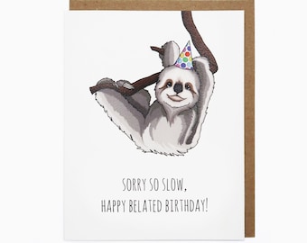 May include: A greeting card with a watercolor illustration of a sloth wearing a party hat and hanging from a branch. The text reads, "SORRY SO SLOW, HAPPY BELATED BIRTHDAY!" The card has a white interior and a brown border.