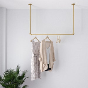 Golden Minimalist Clothes Rack | Garment Rail made of metal mounted on the ceiling Ceiling Clothing rack