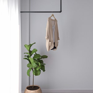 A durable and versatile Industrial Pipe Wall-Mounted Clothing Rack, crafted from high-quality malleable iron, perfect for keeping garments and accessories organized and tidy in any space,