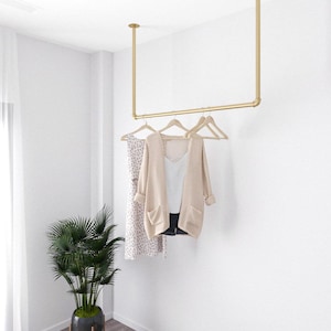 Golden Minimalist Clothes Rack | Garment Rail made of metal mounted on the ceiling Ceiling Clothing rack