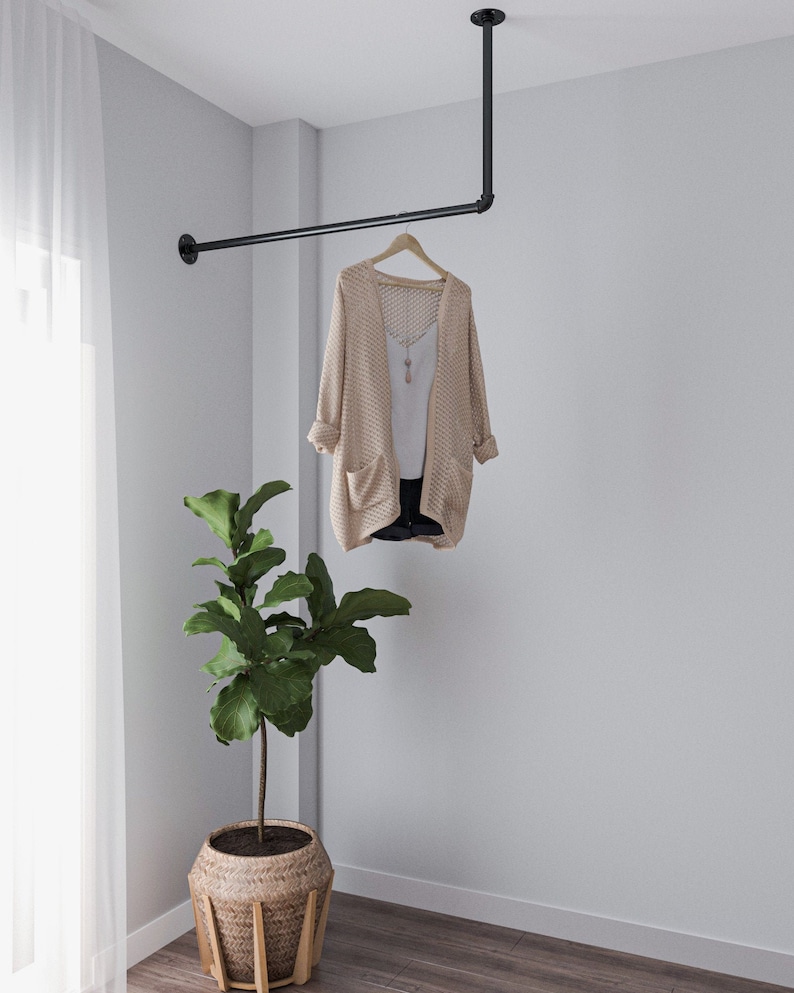 A durable and versatile Industrial Pipe Wall-Mounted Clothing Rack, crafted from high-quality malleable iron, perfect for keeping garments and accessories organized and tidy in any space,