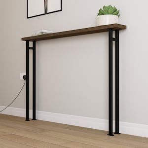May include: A contemporary console table with a dark brown wooden top and black metal legs. The table is approximately 152 cm long and features a minimalist design. A small potted plant and books are on the table.