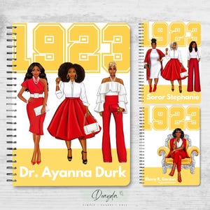 May include: Three yellow and black spiral notebooks with the number 1923 printed on the front. The notebooks feature illustrations of women in red and white dresses. The text "Dr. Ayana Durk", "Soror Stephanie", and "Ebony R. Gordon" is printed on the front of each notebook.