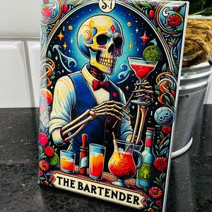 May include: A colorful illustration of a skeleton bartender serving a cocktail. The skeleton is wearing a blue vest and a bow tie. The background is a dark blue with stars and other decorative elements. The text "THE BARTENDER" is at the bottom of the image.