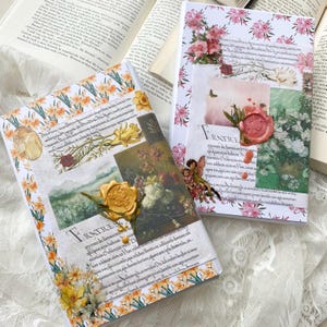 May include: Two decorative journals with floral designs and wax seals. The journal on the left has a yellow and white floral design with a gold wax seal. The journal on the right has a pink and white floral design with a red wax seal. Both journals have text on the front cover.