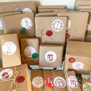 May include: A collection of wrapped brown paper packages, each adorned with a decorative sticker and sealed with wax. The stickers feature numbers and festive Christmas imagery. Some packages are tied with twine.