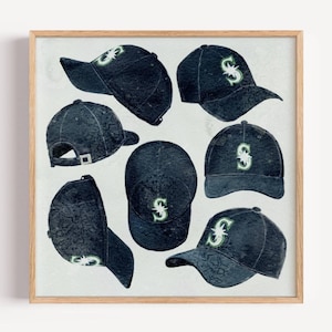 May include: Watercolor print of navy blue baseball caps with a green "S" logo. The caps are displayed from various angles, showcasing the design and shape. The artwork is set against a light background and framed in a wooden frame.