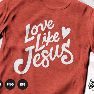 May include: Red t-shirt with white lettering that says "Love Like Jesus" with a small white heart. The text is in a handwritten style font.
