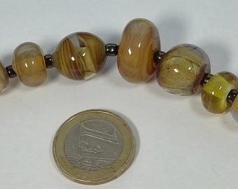7 handmade green/golden glassbeads by Petra Hergarden made out of Italian Murano glass only one time made
