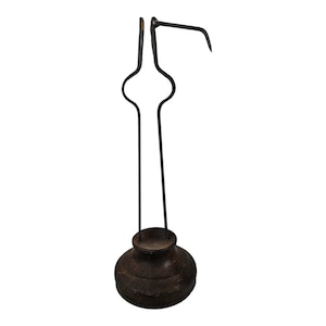 May include: A black metal fireplace tool with a wooden base. The tool has a hook on the end and a long handle.