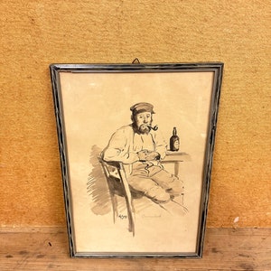 May include: A framed black and white drawing of a man sitting in a chair with a pipe in his mouth and a bottle in his hand. The drawing is signed "6571" and "Ormond".