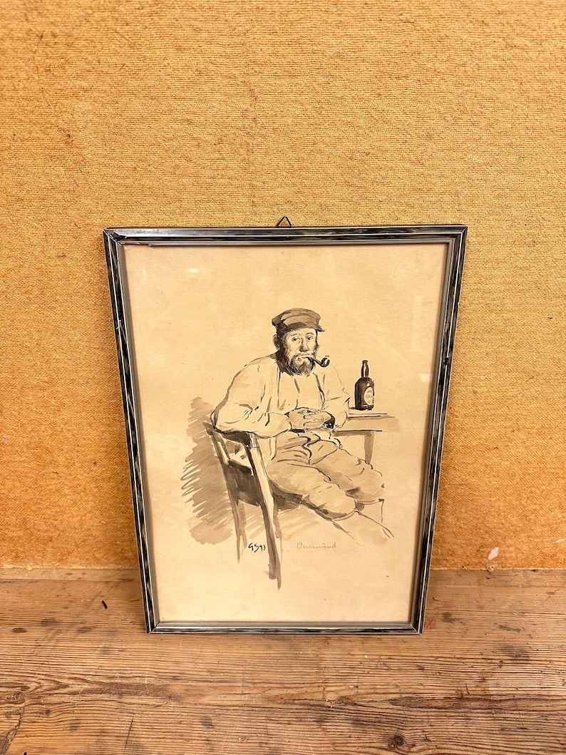May include: A framed black and white drawing of a man sitting in a chair with a pipe in his mouth and a bottle in his hand. The drawing is signed "6571" and "Ormond".