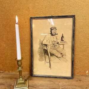 May include: A framed black and white drawing of a man sitting in a chair, holding a pipe and a bottle. The man is wearing a cap and has a beard. The drawing is signed "4571" and "Ormond".