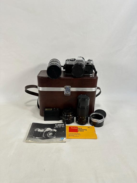 Vintage Canon AT-1 35mm SLR Camera Set with 4 Lenses and Flash - Perfect Gift for Camera Enthusiasts