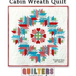 May include: A quilt pattern featuring a log cabin wreath design with hearts in the center. The quilt is made with red, green, blue, and white fabrics. The finished size is 26 inches square. "Hearts in the Log Cabin Wreath Quilt" and "Quilters Trading Post" are printed on the image.