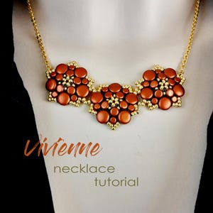 May include: A gold chain necklace with three large, orange, beaded flower-shaped pendants. The necklace is on a model wearing a black shirt. The text "Vivenne necklace tutorial" is below the necklace.