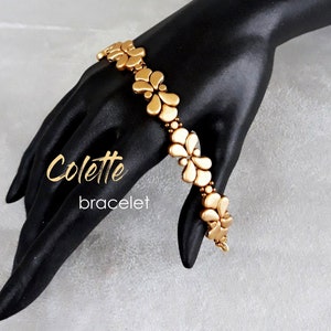 Könnte beinhalten: Ein goldfarbenes Armband mit Blumenmuster. Das Armband heißt "Colette Armband".