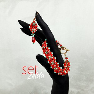 May include: A red and turquoise beaded bracelet and earrings set. The bracelet has a gold clasp and the earrings have a gold hook.