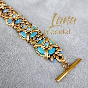 May include: A gold and blue beaded bracelet with a toggle clasp. The bracelet features a repeating pattern of turquoise and gold beads. The text "Lana bracelet" is visible in the image.