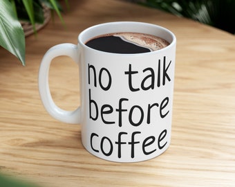 May include: White coffee mug with black text that reads "no talk before coffee".