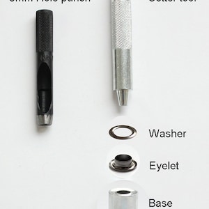 May include: A set of tools for installing eyelets, including an 8mm hole punch, a setter tool, a washer, an eyelet, and a base. The tools are silver and black.