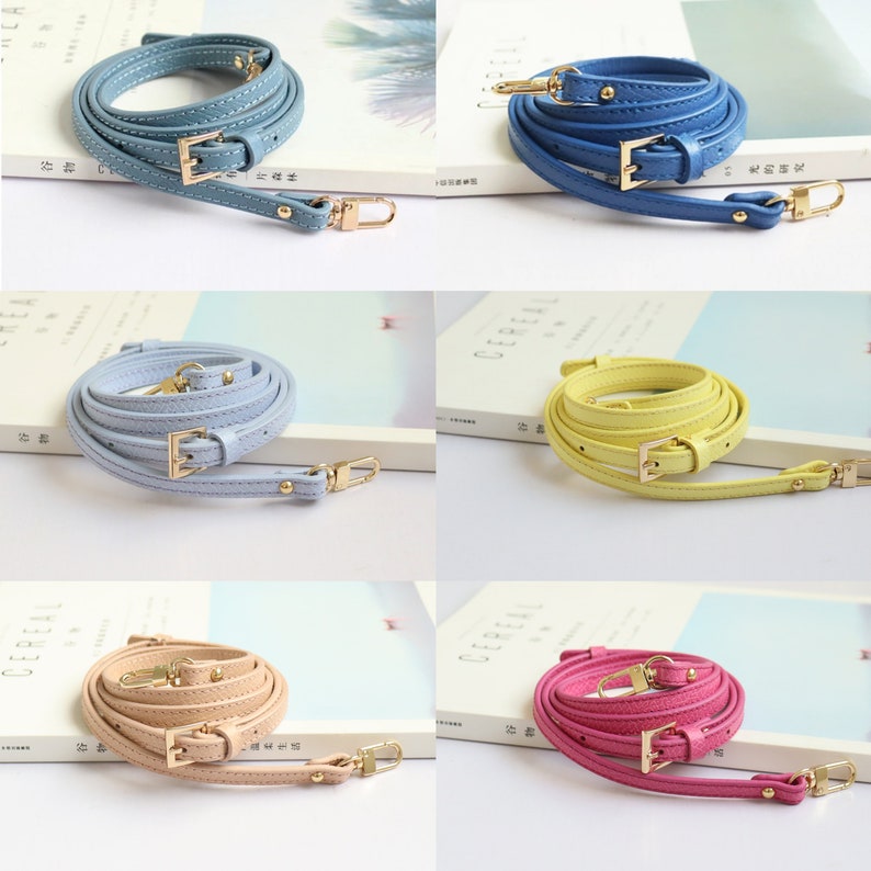 May include: Four different coloured leather straps with gold buckles and clasps. The straps are light blue, yellow, beige, and pink.