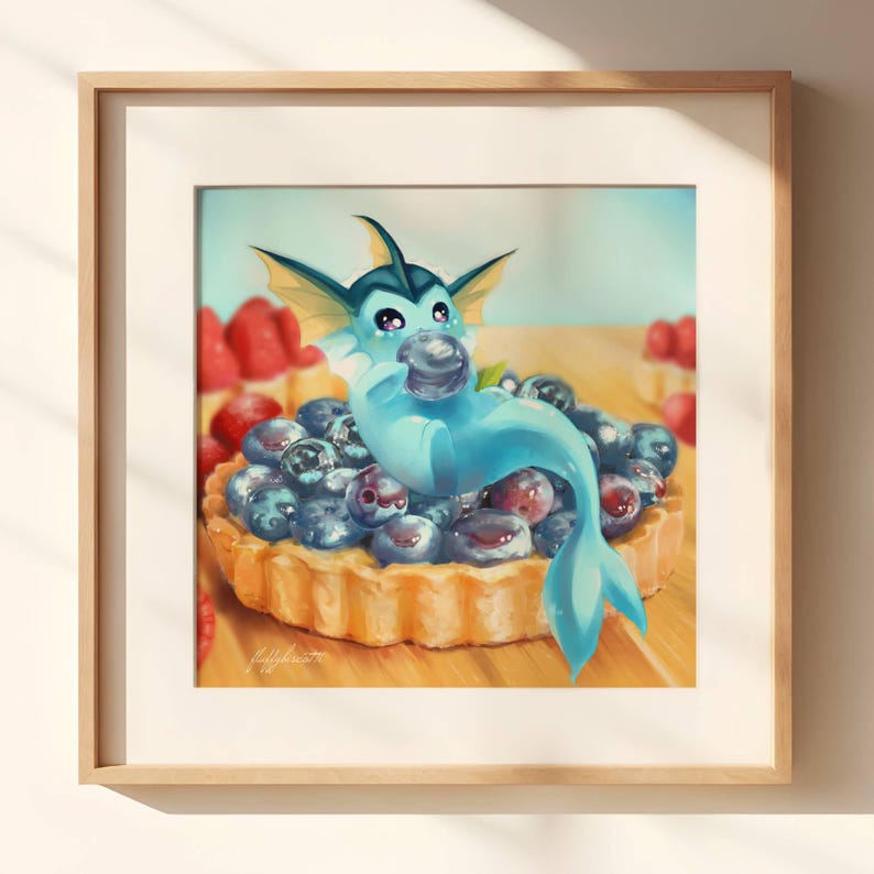 May include: A blue and white cartoon water Pokemon with fins and a tail is sitting on a blueberry tart. The tart is on a wooden surface.