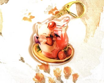 May include: A clear acrylic keychain featuring a cartoon character enjoying a strawberry drink. The keychain has a gold-colored clasp. The drink is in a glass jar with a straw, and there are fresh strawberries on the plate.
