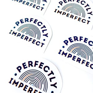 May include: Five stickers with a rainbow design and the text "Perfectly Imperfect" in black and orange lettering.