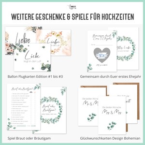 May include: A set of printable wedding cards and games with a bohemian theme. The cards feature a green and white floral design with the text "Liebe liegt in der Luft" and "Gemeinsam durch Euer erstes Ehejahr". The games include a "Braut oder Br&auml;utigam?" game and a "Guess the Gift" game.
