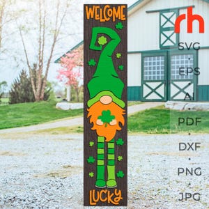 May include: A wooden welcome sign with a green leprechaun holding a shamrock. The sign says "Welcome" and "Lucky" in orange letters.