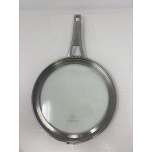 May include: A stainless steel frying pan with a long handle and a clear glass lid. The pan is round with a silver rim and a clear glass center. The handle has a hole at the end for hanging.