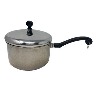 May include: A stainless steel saucepan with a lid and a black handle. The lid has a black knob. The handle is curved and has a hole at the end. The saucepan is designed for cooking.