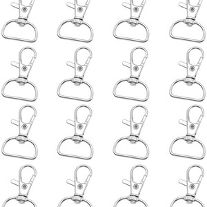 May include: A set of 20 silver-toned metal swivel lobster clasps. The clasps are approximately 1 inch in length and have a D-ring opening.