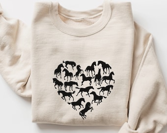 May include: A beige sweatshirt with a black silhouette of a heart made up of horses.
