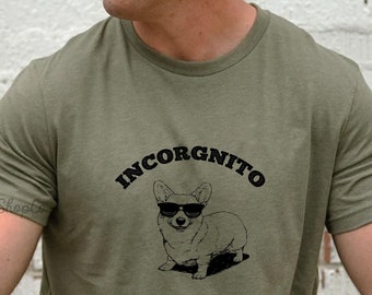 Könnte beinhalten: Ein grünes T-Shirt mit einer schwarzen Grafik eines Corgis mit Sonnenbrille und dem Text "INCORGNITO".