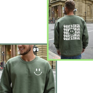 May include: Green sweatshirt with a white smiley face on the front and the text "GODFATHER" repeated with a smiley face in the middle on the back.