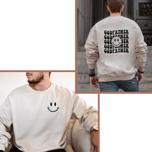 May include: A beige sweatshirt with a black smiley face on the front and the text "GODFATHER" repeated multiple times on the back.