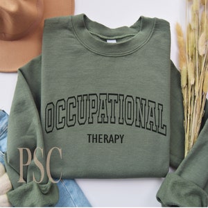 May include: A green sweatshirt with the text "OCCUPATIONAL THERAPY" in black lettering.