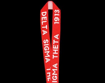 May include: A red lanyard with white text. The text reads "DELTA SIGMA THETA 1913". The lanyard is made of a woven material and has a loop at the top.