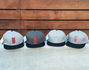 Light Gray or Black Trucker Hat Good Luck Red Tiki on Black /& White