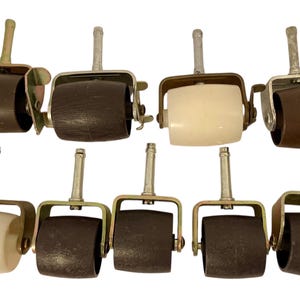 May include: A collection of ten vintage furniture casters. The casters have brown and cream-colored wheels, metal frames, and silver stems. Some have wing nuts for easy adjustment. Ideal for antique furniture restoration.